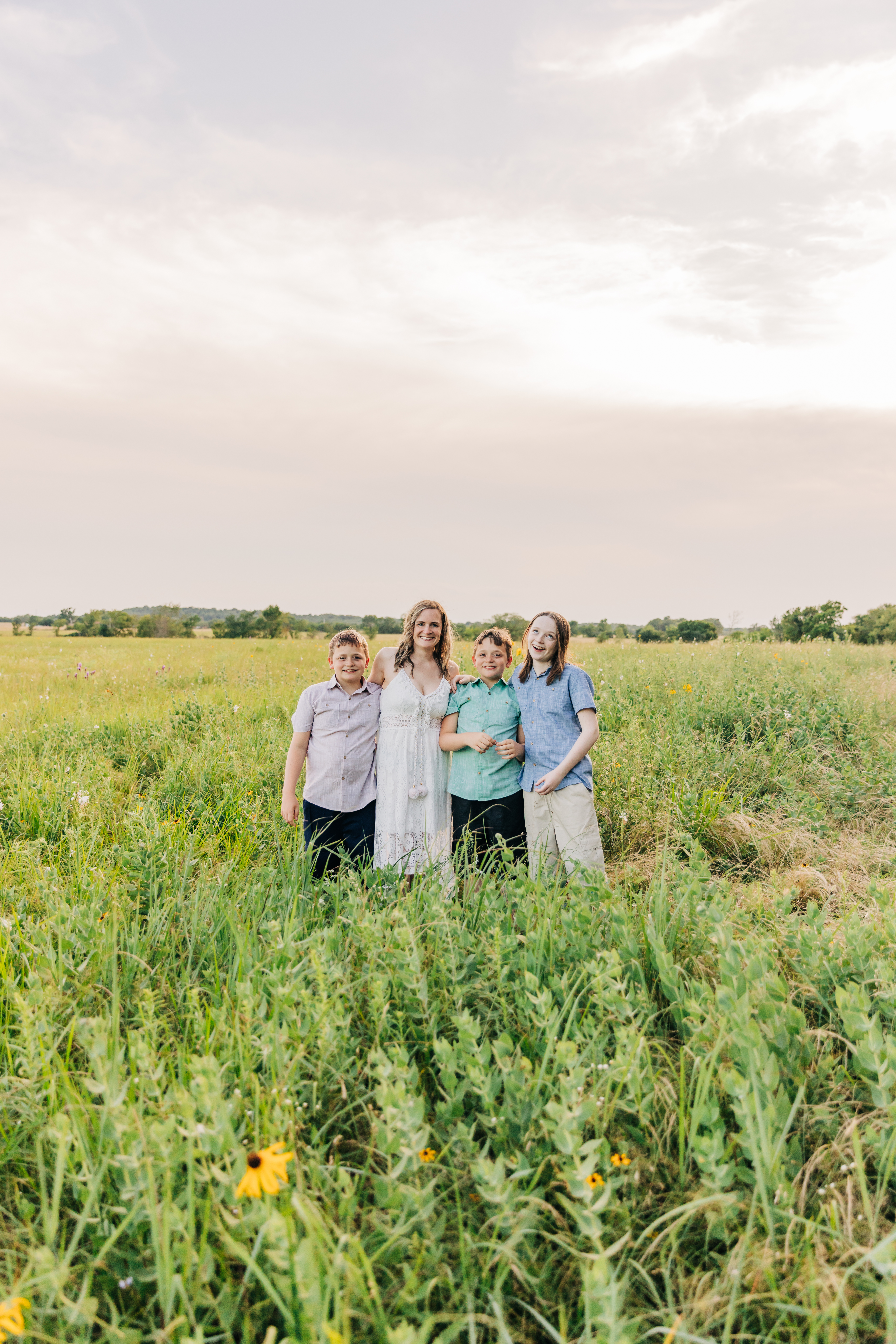 Photo with Julie Bowen and her three boys in a field  